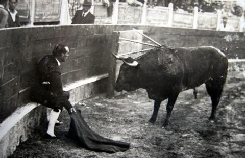 Ignacio Sánchez Mejías toreando sentado en el estribo de la barrera