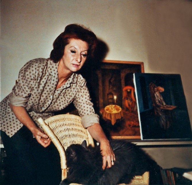 (Remedios Varo en su estudio con su gato Zorrillo. Al fondo sus cuadros Presencia Inquietante y Visita Inesperada- foto de Kati Horna 1959)
